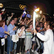 Pat Rafter with the Olympic Torch.Pat Rafter with the Olympic torch. Photo by Mike Ke in front of the Sydney Harbour Bridge and Olympic rings. This was a fantastic promotional opportunity for the Sydney 2000 Olympics and an exciting moment for the crowd. Click to view enlarged image